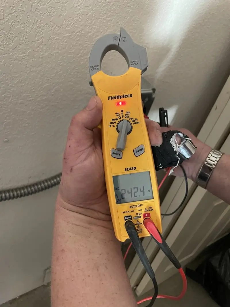 Voltage testing with clamp meter during Whole House Surge Protector in Havre